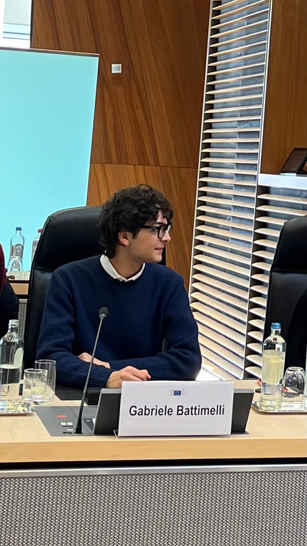 Gabriele Battimelli seated behind his nameplate at the European Commission