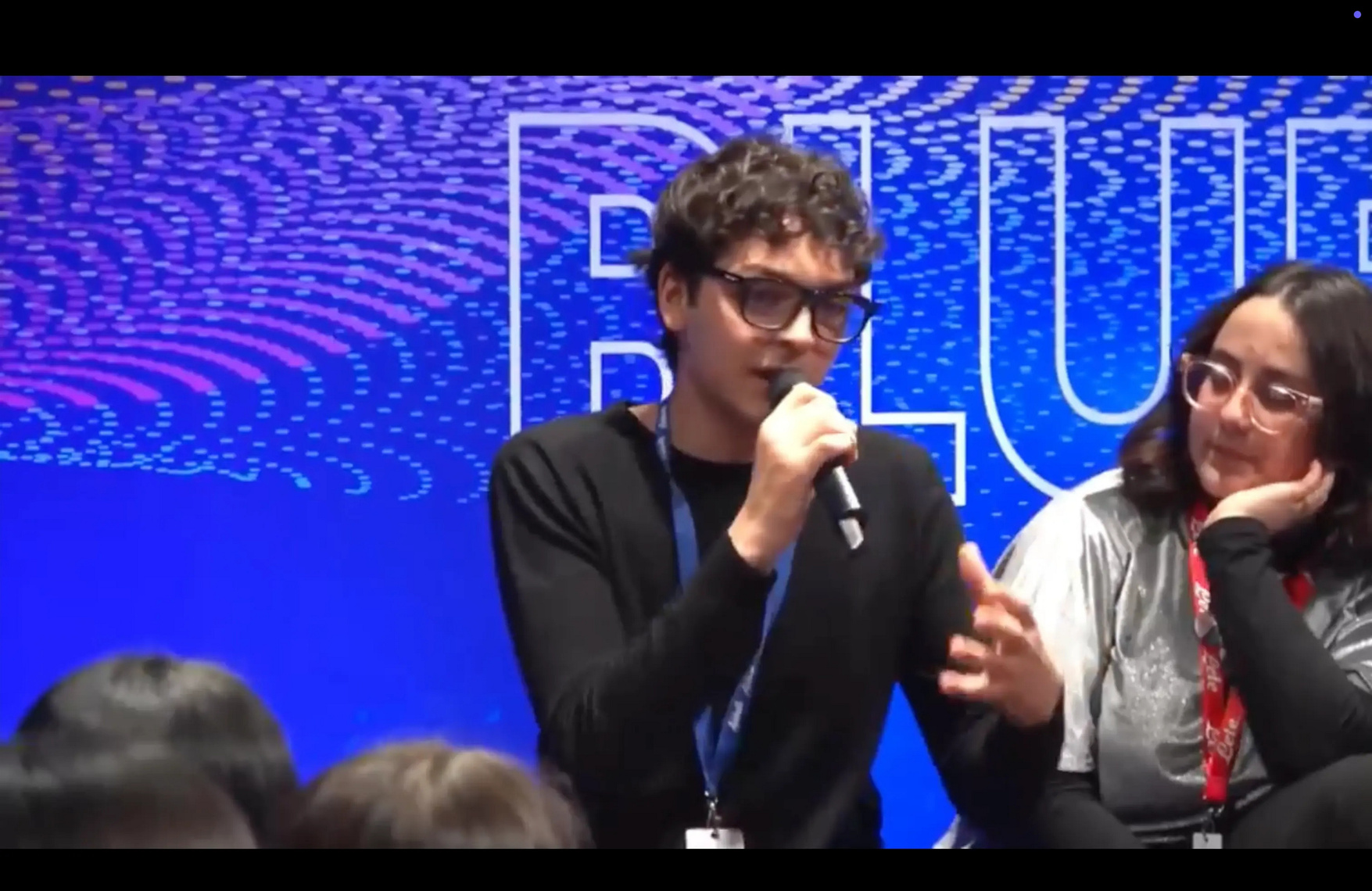 Speaking on a panel with a microphone